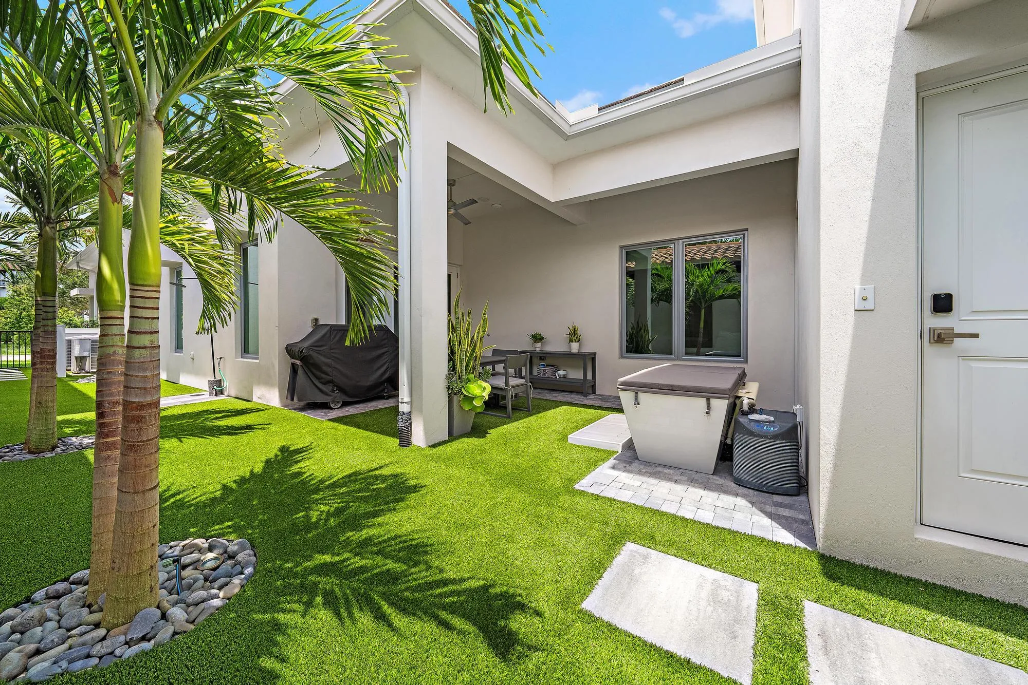 The backyard offers a covered lanai with turf grass & beautiful landscaping
