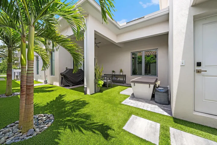The backyard offers a covered lanai with turf grass & beautiful landscaping