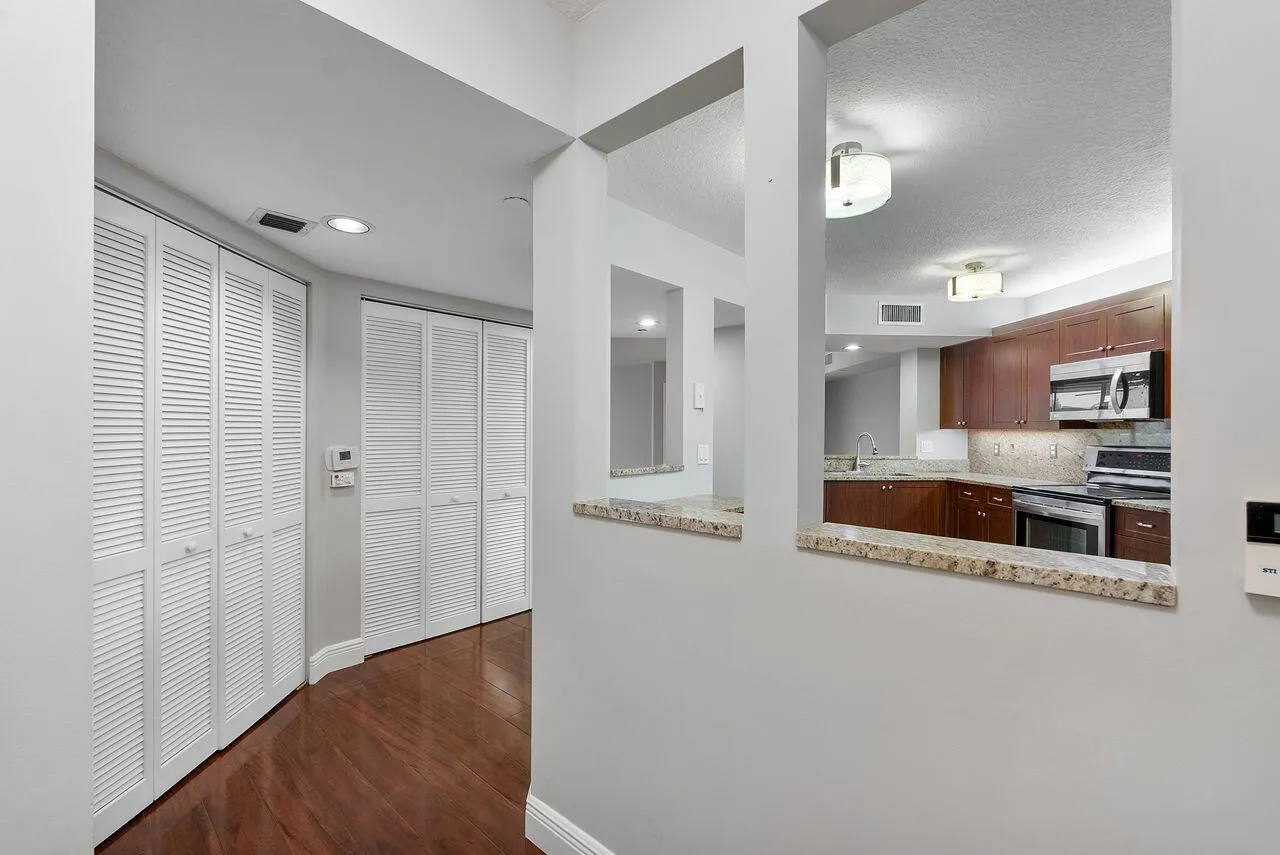 Entry way with linen closet and washer and dryer in condo