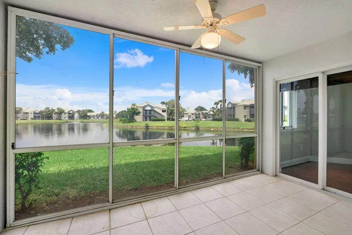 Enclosed and screened in back patio on lake