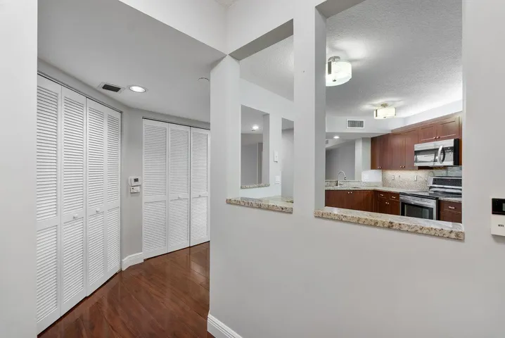 Entry way with linen closet and washer and dryer in condo