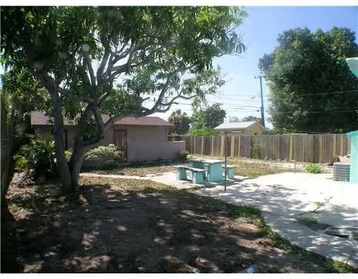 SPACIOUS YARD IS TOTALLY ENCLOSED IN COMMERCIAL FENCE!