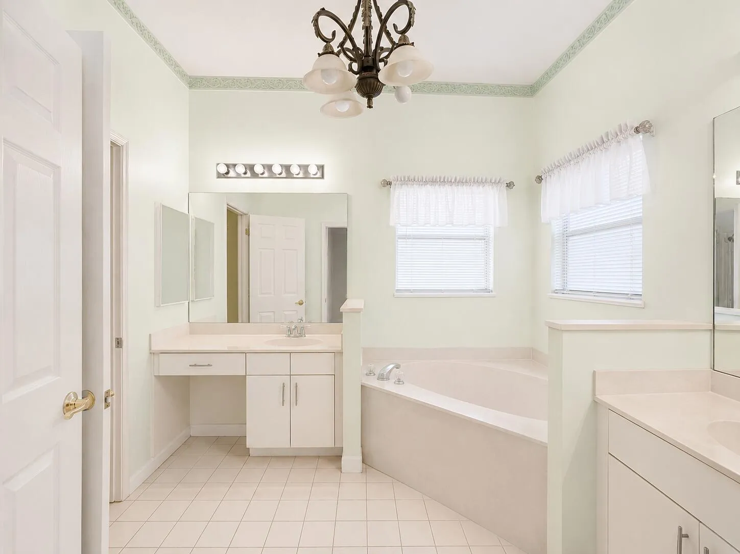 Bright minimalist primary bathroom with vintage chandelier. Digitally Enhanced Photo.