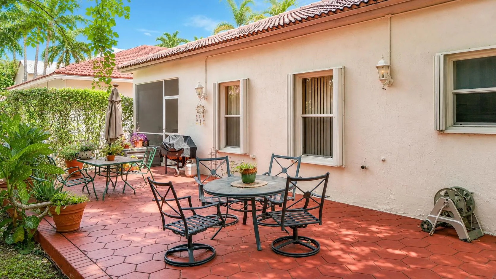 Sunny backyard patio with tropical charm.