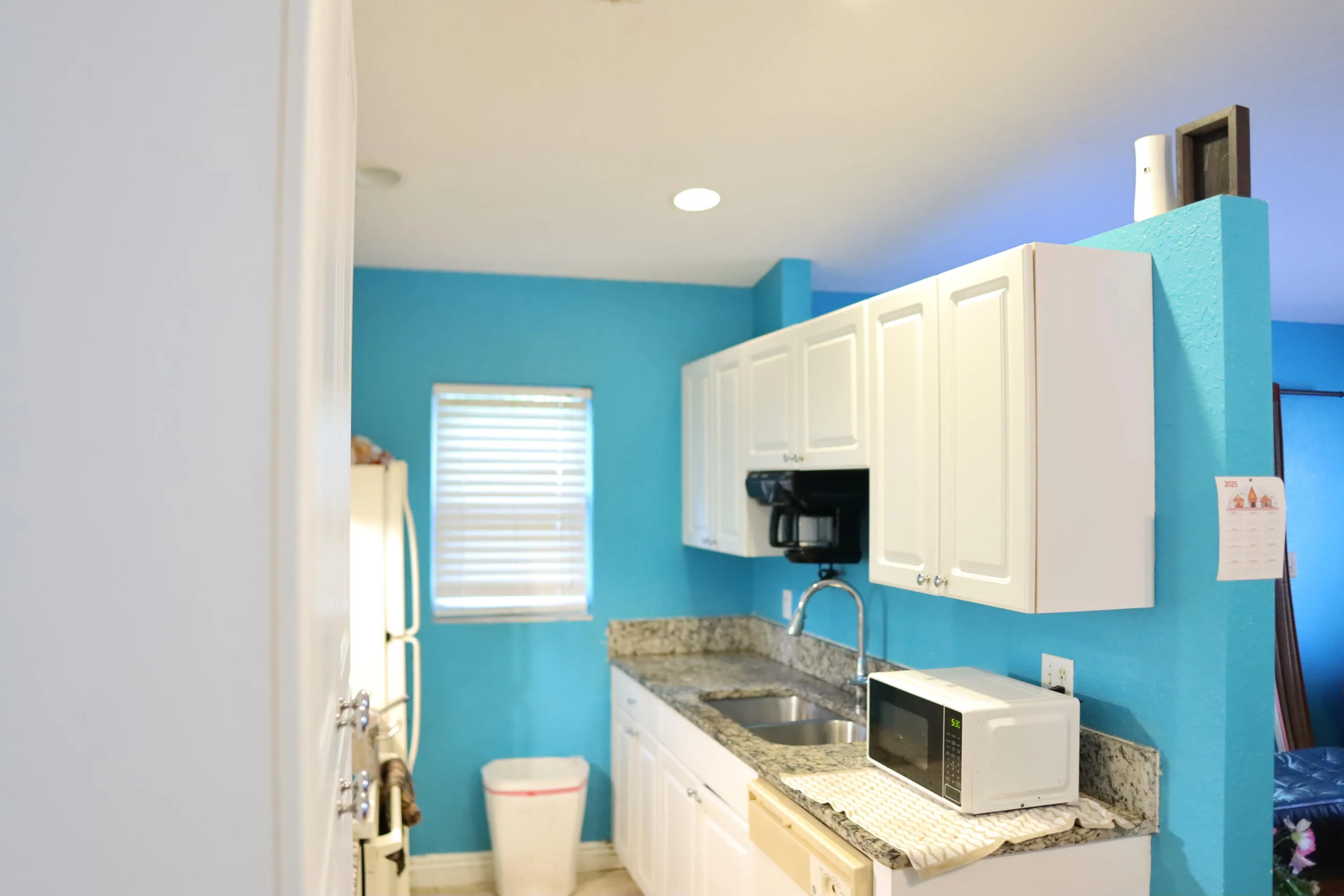 Kitchen area with all white Cabinets.