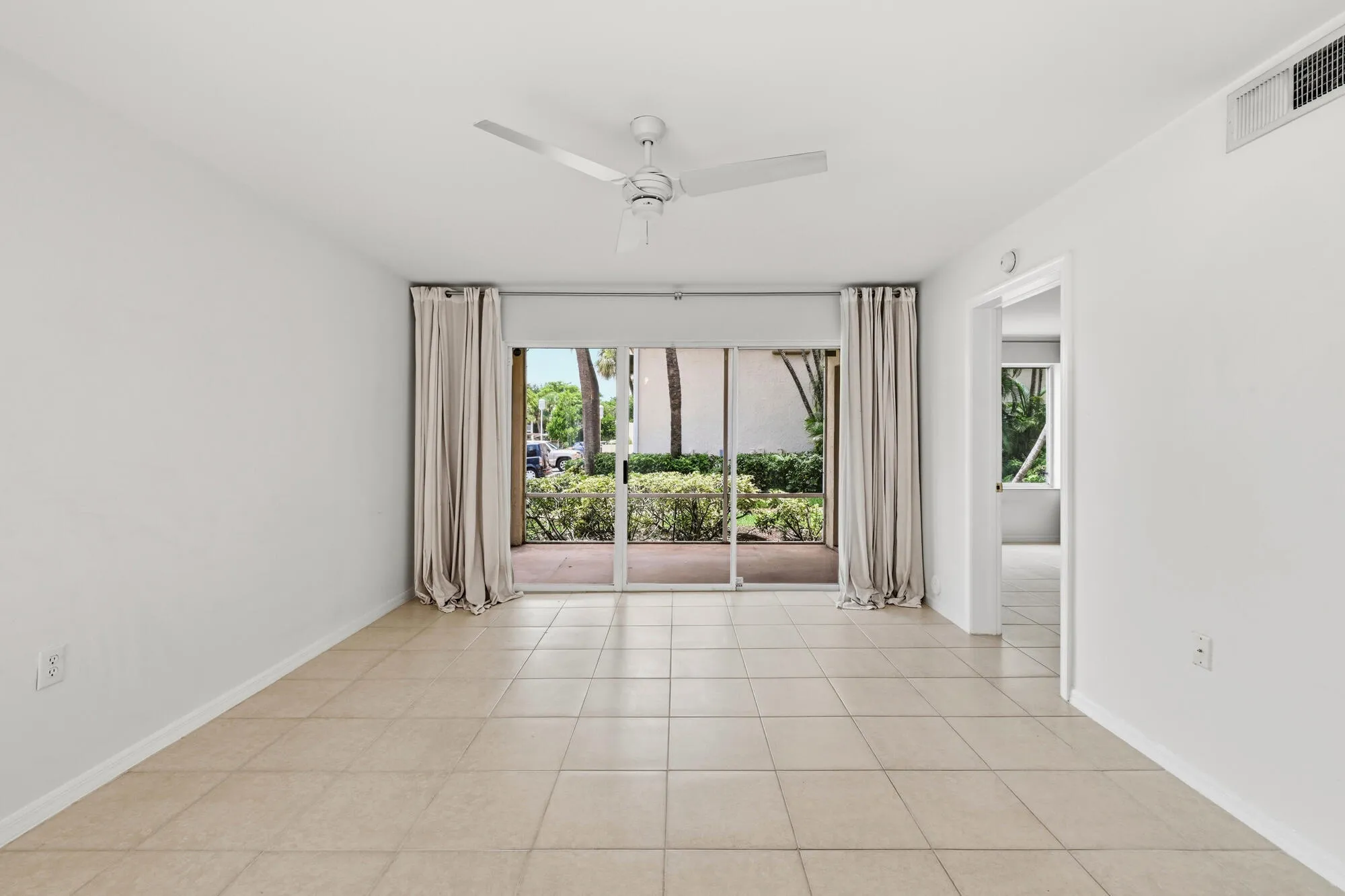 Living area with tile flooring and a ceiling fan