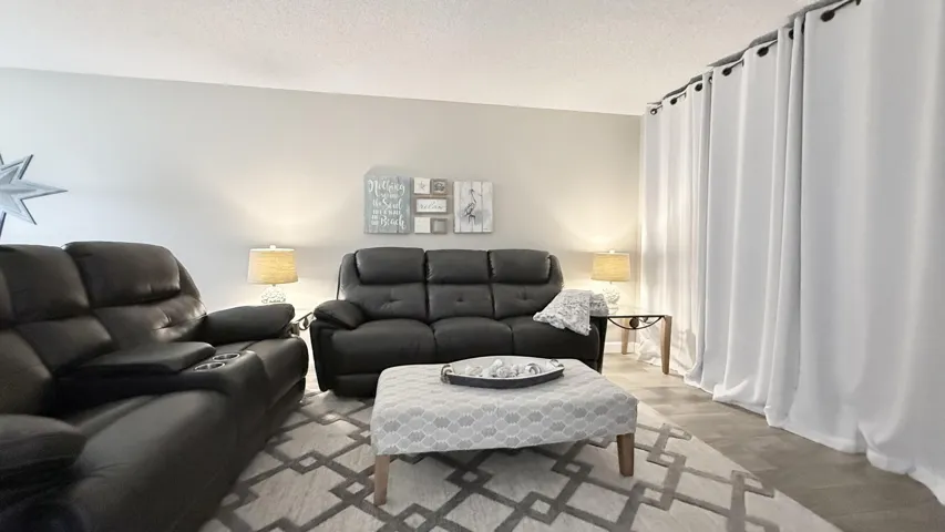 Space to unwind and look out onto the screened patio, beautifully furnished...ready to rent or move in!