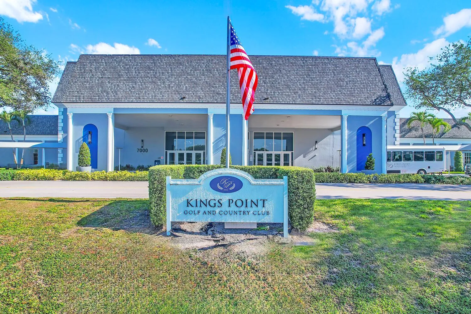 Kings Point Golf and Country Club entrance sign framed by manicured hedges