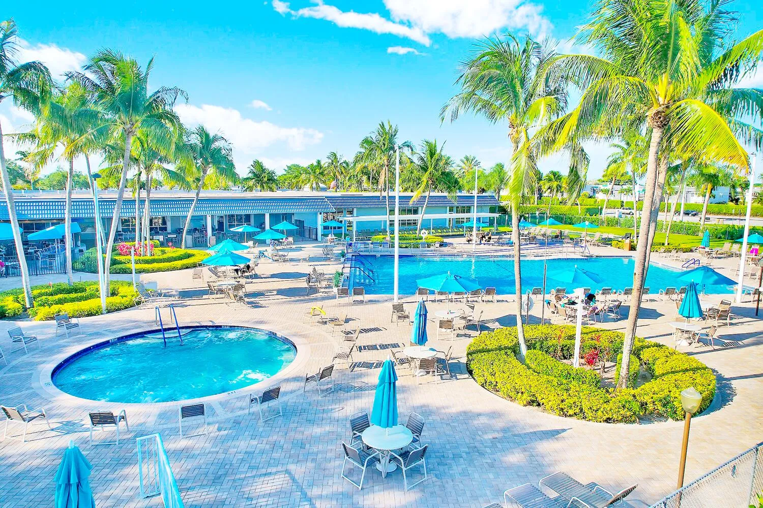 Expansive outdoor recreation area featuring multiple swimming pools, a spa, and extensive patio seating