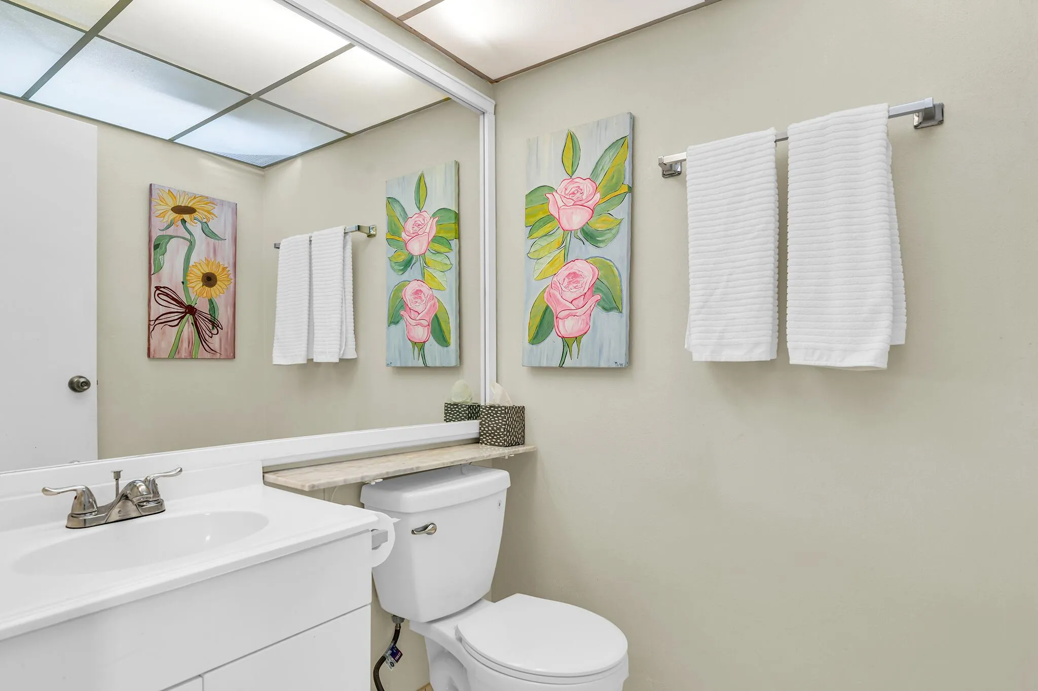 Bathroom featuring a large vanity with white cabinetry, a rectangular sink, and chrome fixtures