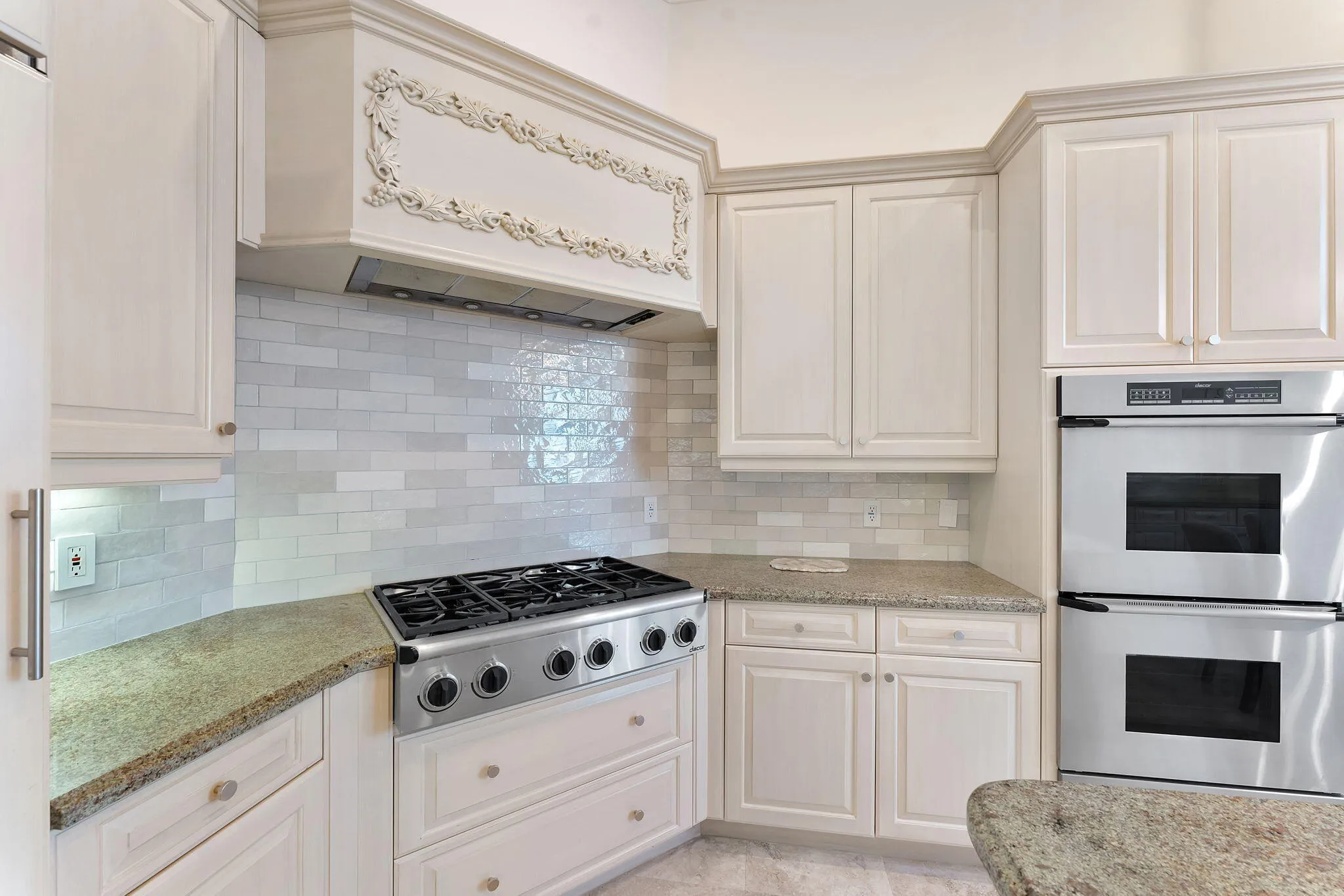 Kitchen with dual wall oven and gas range.