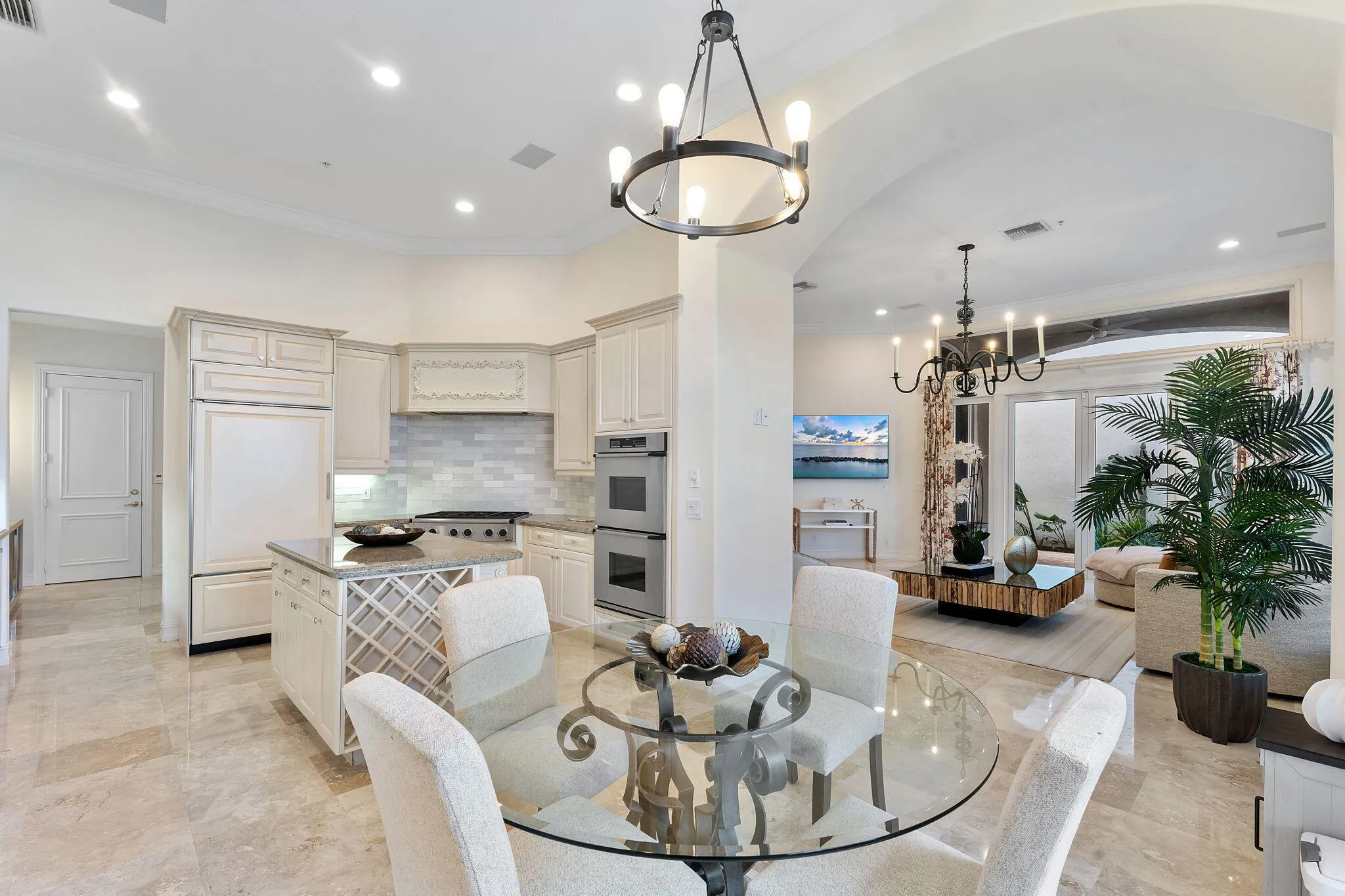 Open kitchen with gas range and double wall ovens.