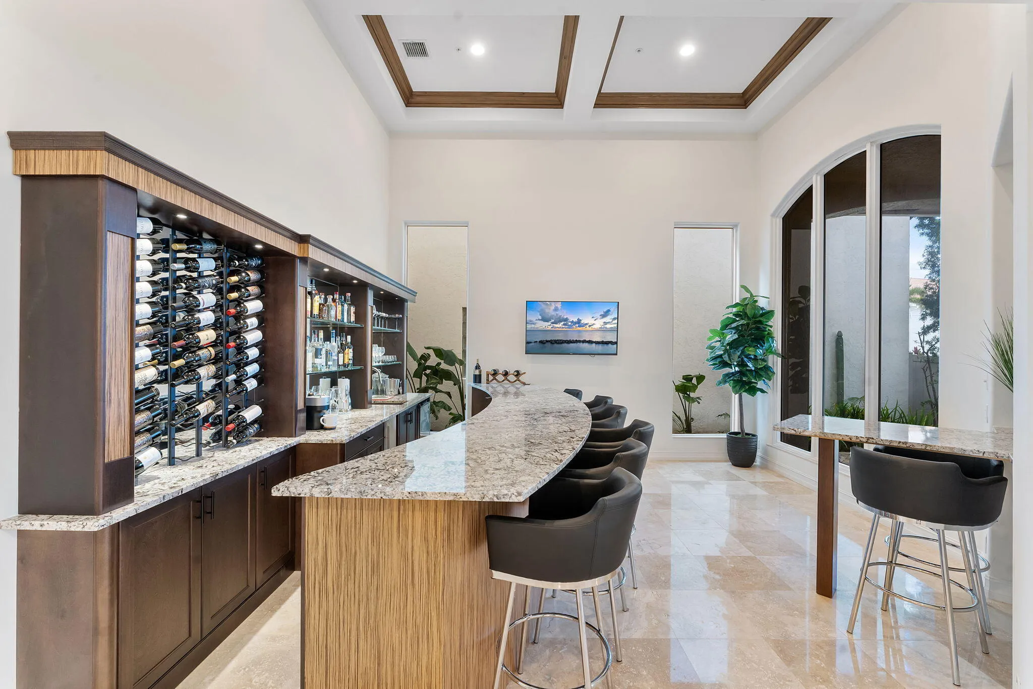 Custom built bar with sink, ice maker, refrigerator, and wine refrigerator. (Bar is built on top of the floor and can be removed without any necessary floor renovation).