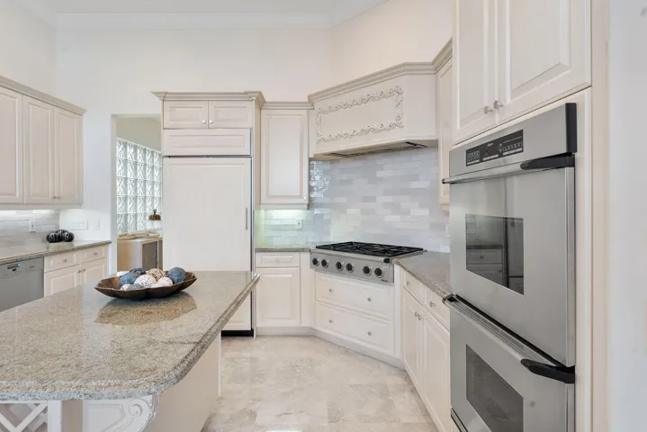 Kitchen with dual wall oven and gas range.