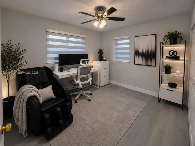 Versatile bedroom currently staged as a home office, offering a spacious closet and endless possibilities to fit your lifestyle.