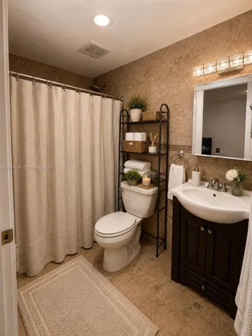 Private primary en-suite bath featuring a walk-in shower, timeless tile finishes, and a functional vanity with additional storage.