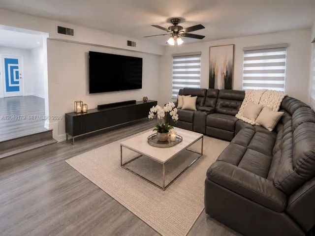 The spacious Florida room provides a versatile extension of the living space—ideal for relaxing, entertaining, or creating the ultimate media room.