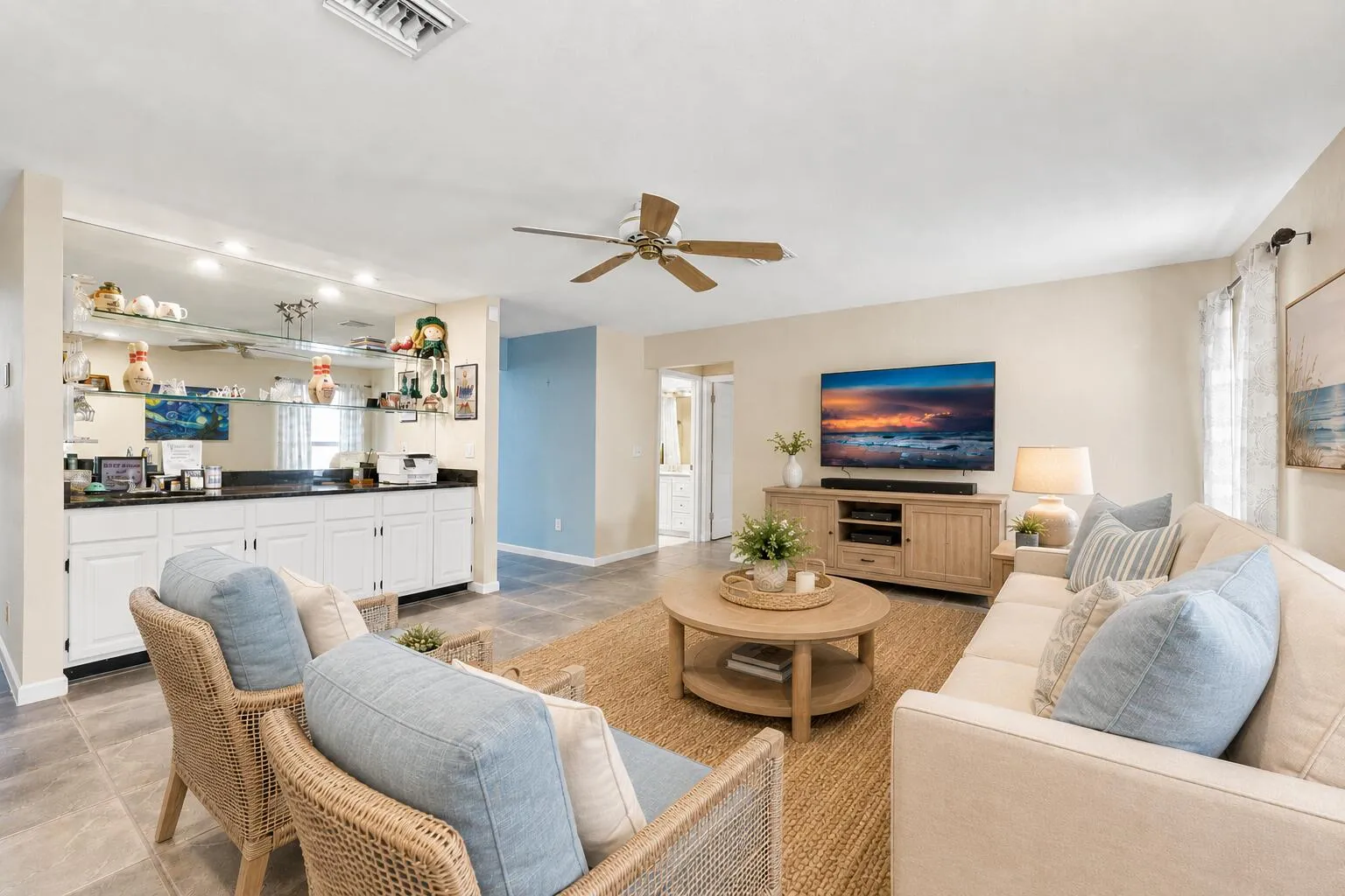 Living area featuring tile flooring, a ceiling fan, and recessed lighting