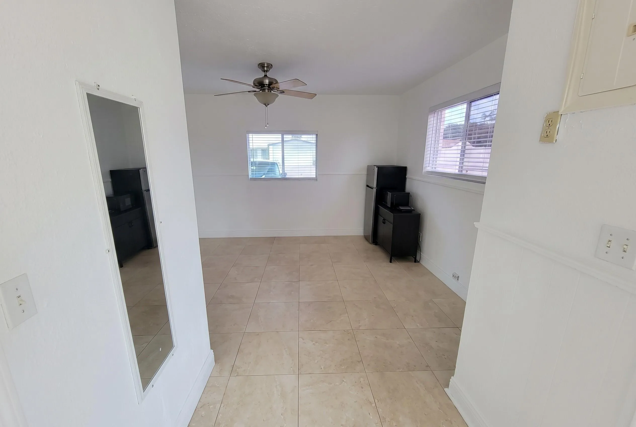 Open concept space with neutral tile flooring