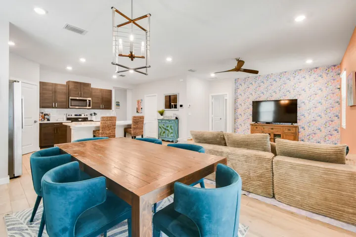 Open-concept living area featuring wood-plank tile flooring, recessed lighting, and a contemporary ceiling fan