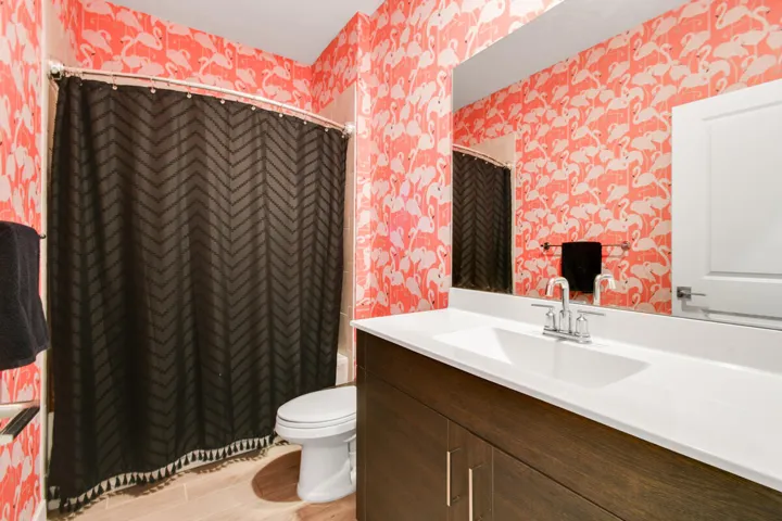 Bathroom featuring a vanity with a white countertop and integrated sink, chrome faucet, and wood-finish cabinetry
