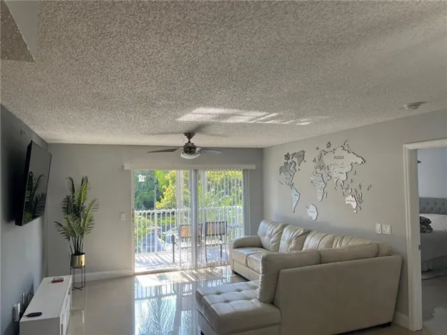 Sliding glass doors opening to an outdoor balcony with white railings