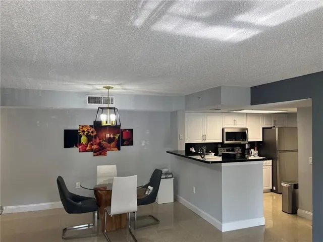 Open-concept living space with light-toned flooring