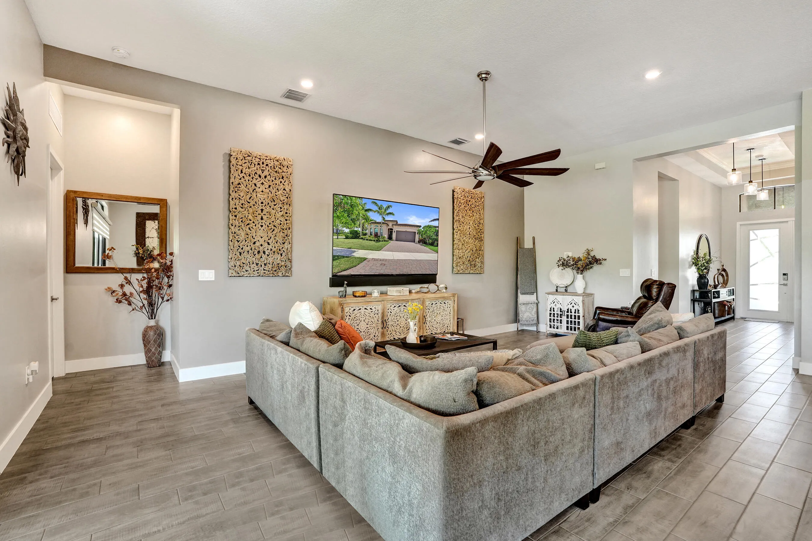 Spacious living area featuring recessed lighting, and a modern ceiling fan