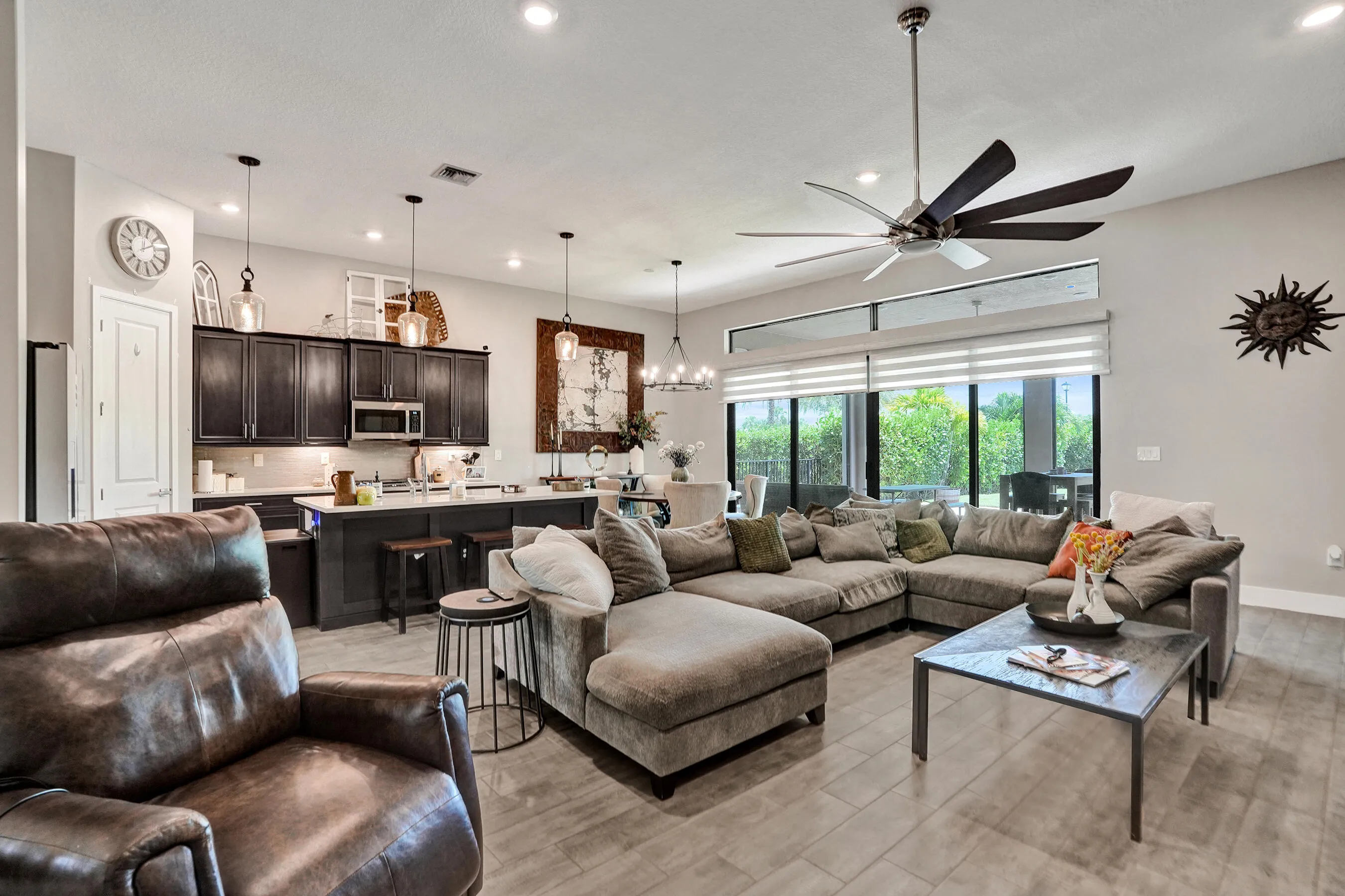 Open-concept living space with 4 panel patio doors to patio