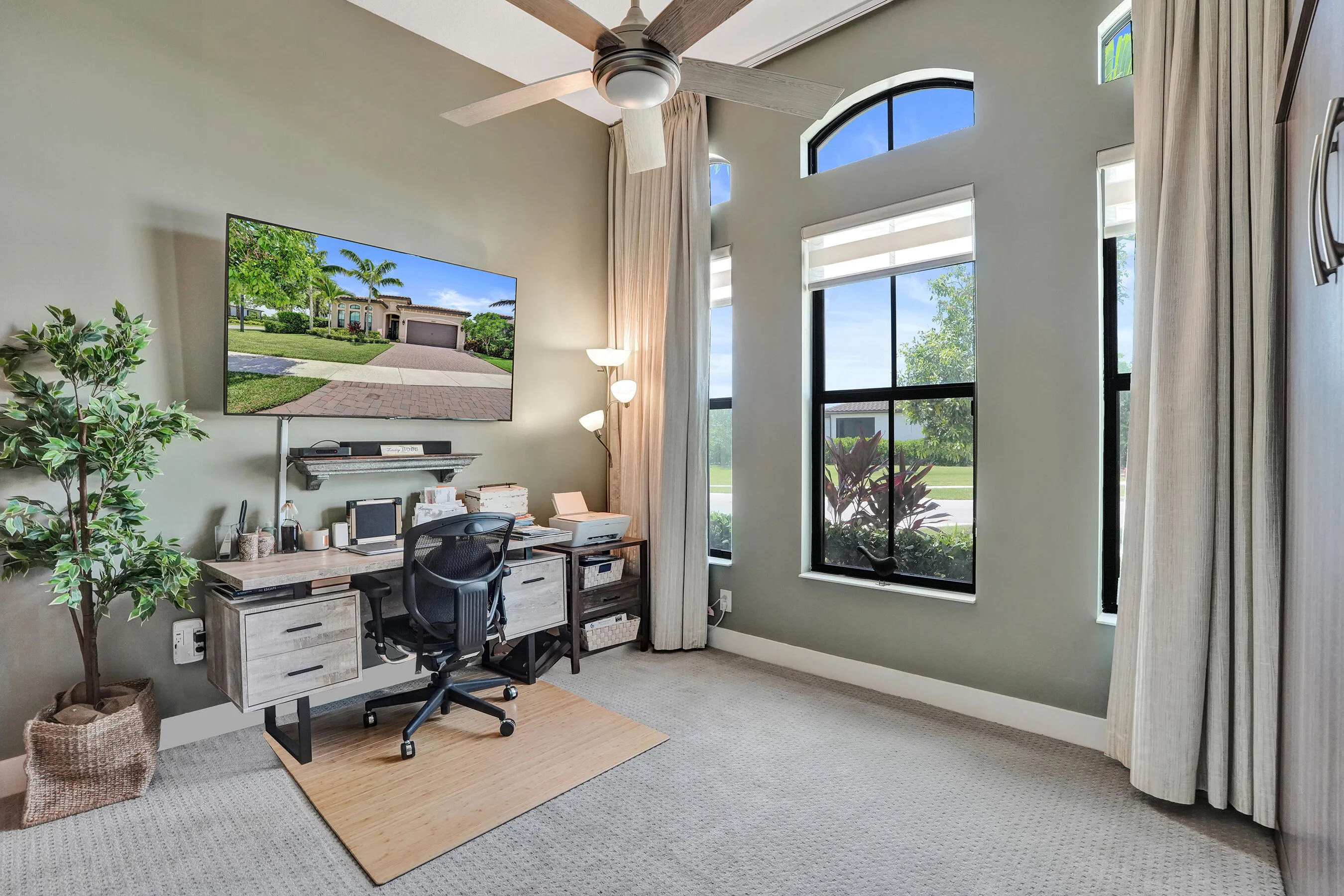 Bedroom 2 has multiple windows with transoms, recessed window treatments, ceiling fan