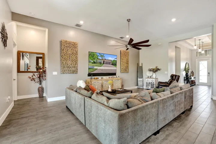 Spacious living area featuring recessed lighting, and a modern ceiling fan
