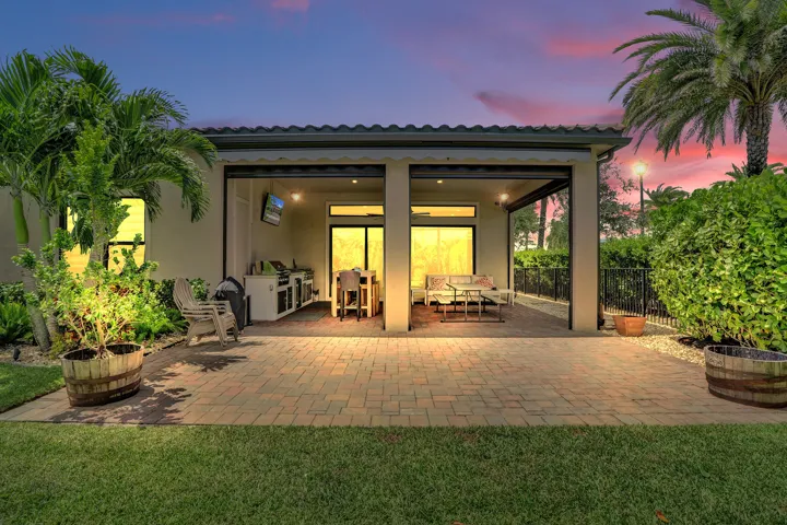 Expansive paver patio featuring a covered outdoor living area