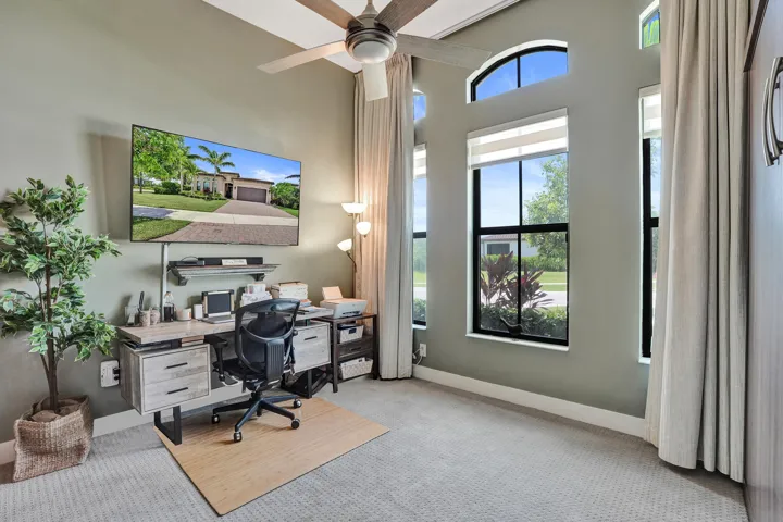 Bedroom 2 has multiple windows with transoms, recessed window treatments, ceiling fan