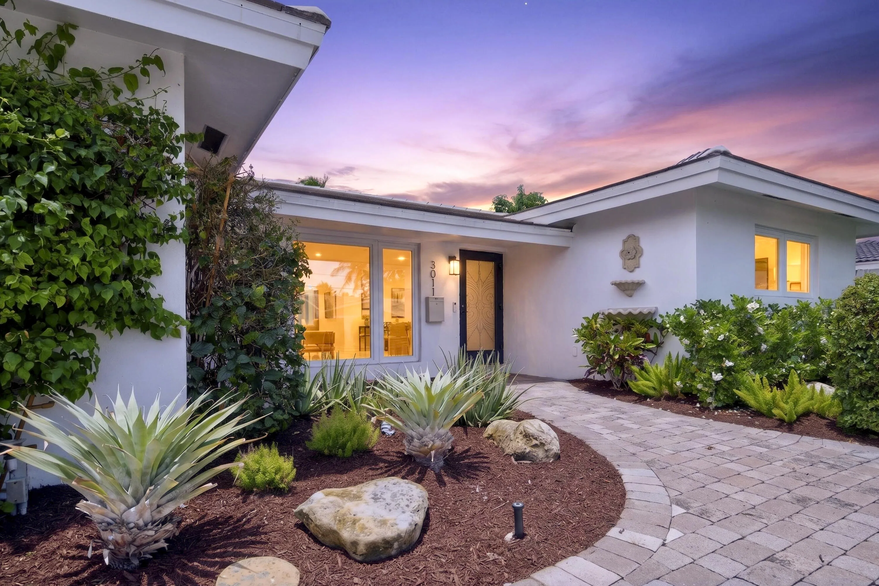 White stucco exterior with a tiled roofline