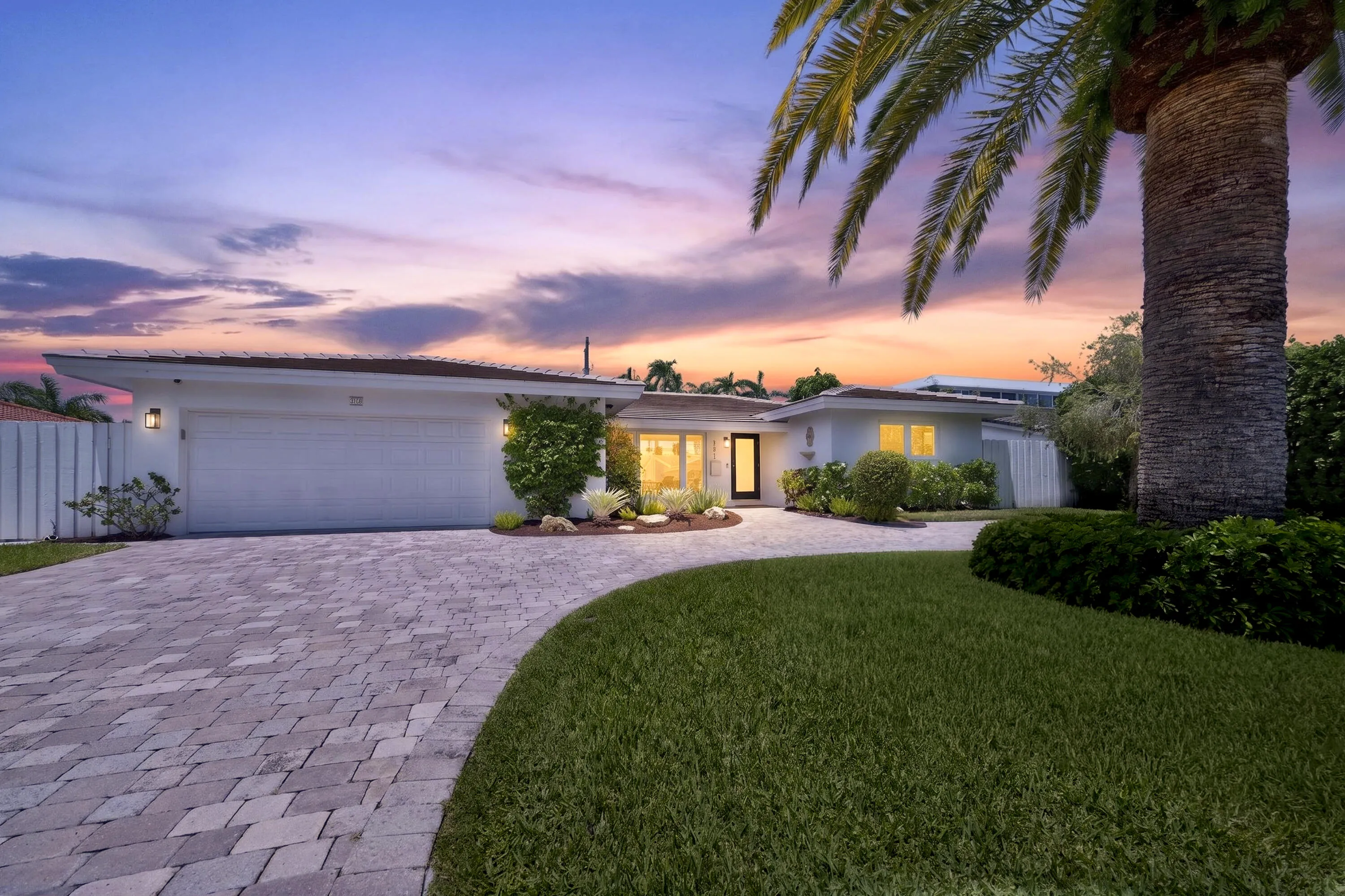Contemporary single-story residence with a paver driveway