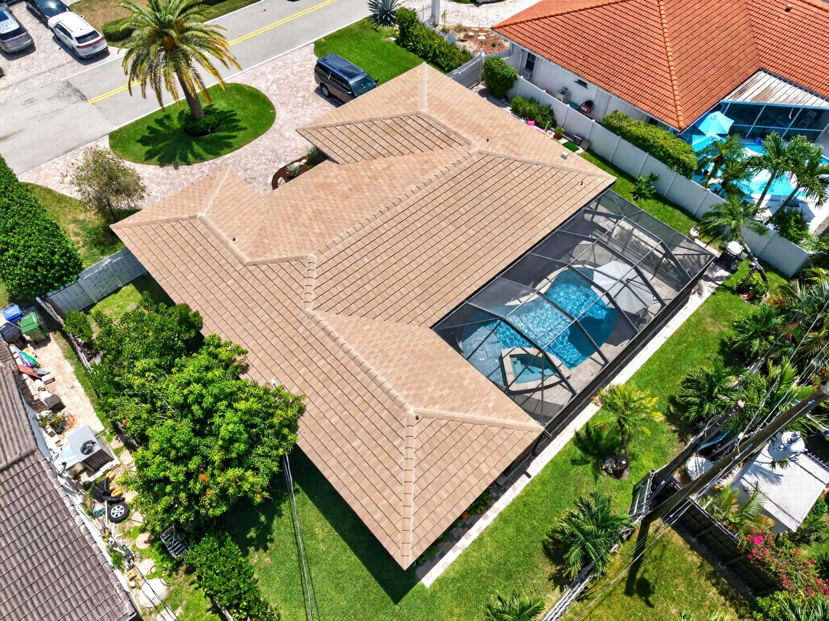 Property featuring a screened-in swimming pool with a blue tiled interior