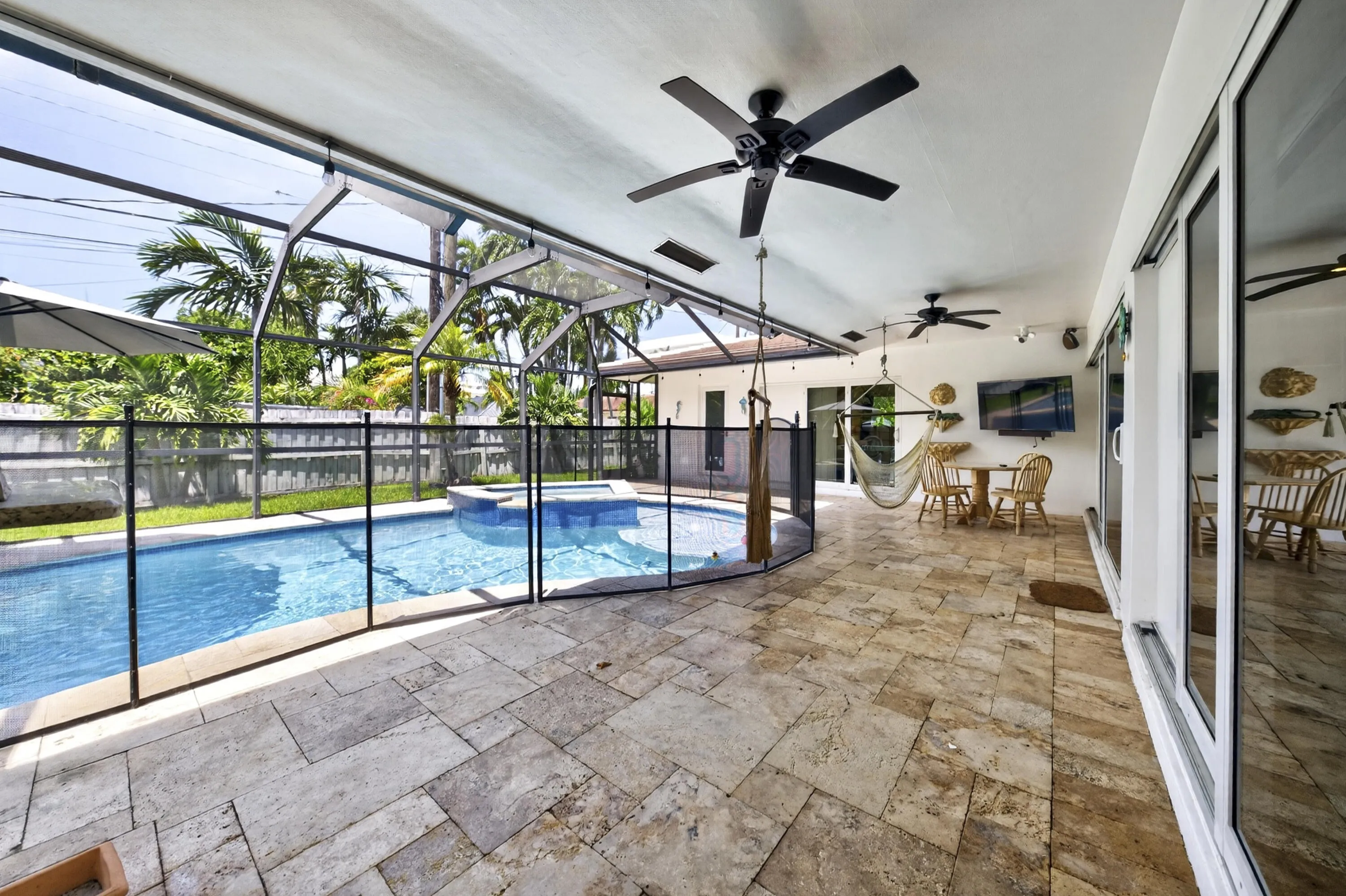 Screened patio with stone tile flooring