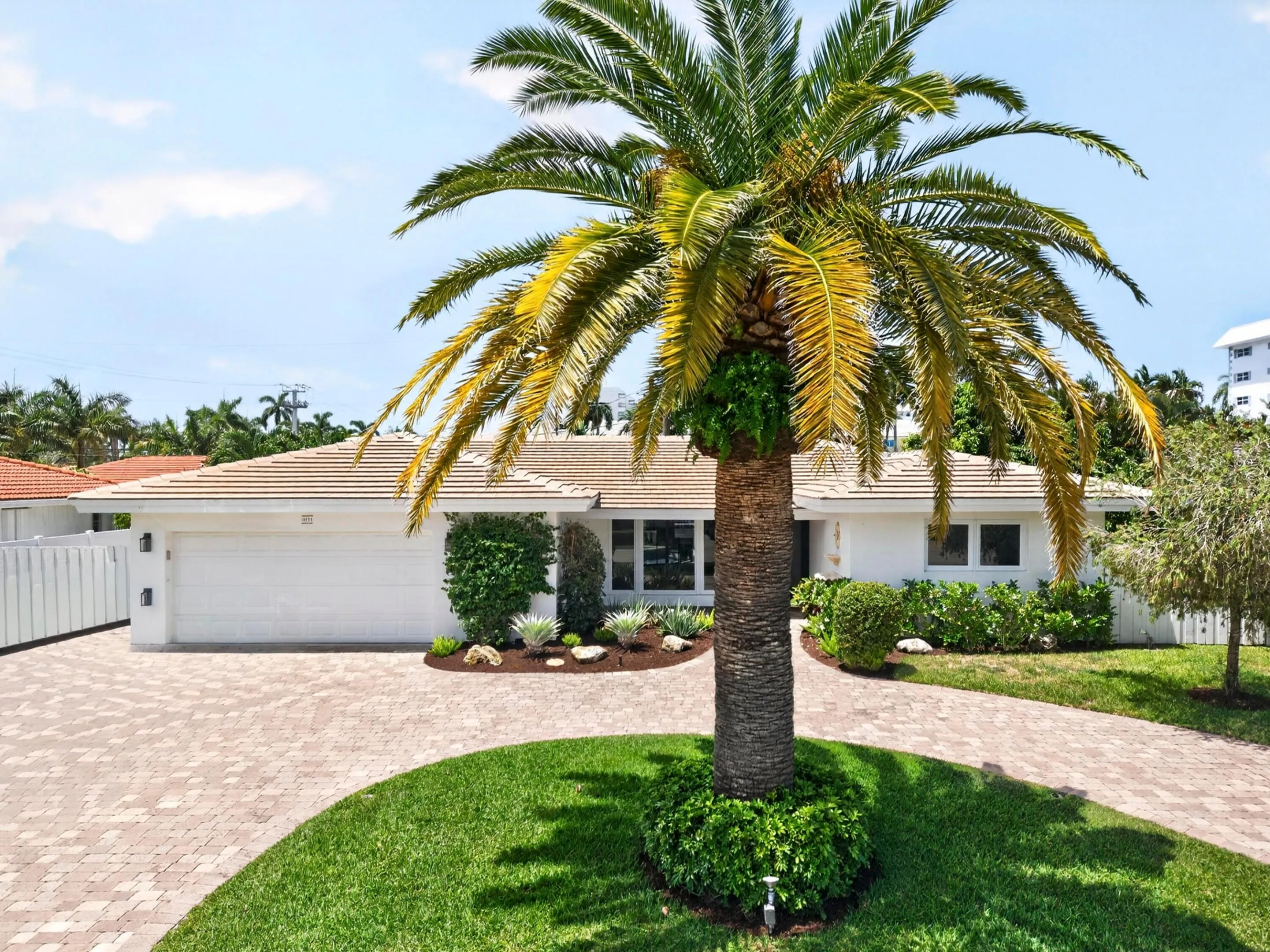 White exterior residence featuring a tiled roof and a two-car garage