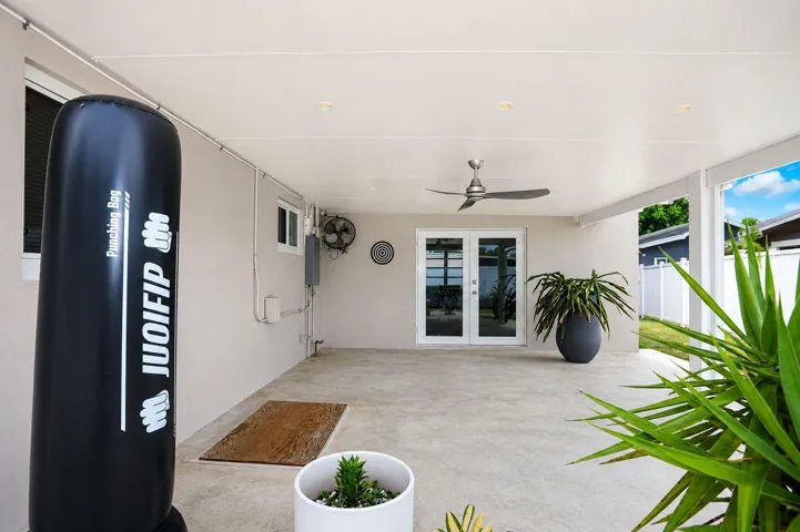 Expansive covered patio featuring a ceiling fan, recessed lighting, and durable concrete flooring