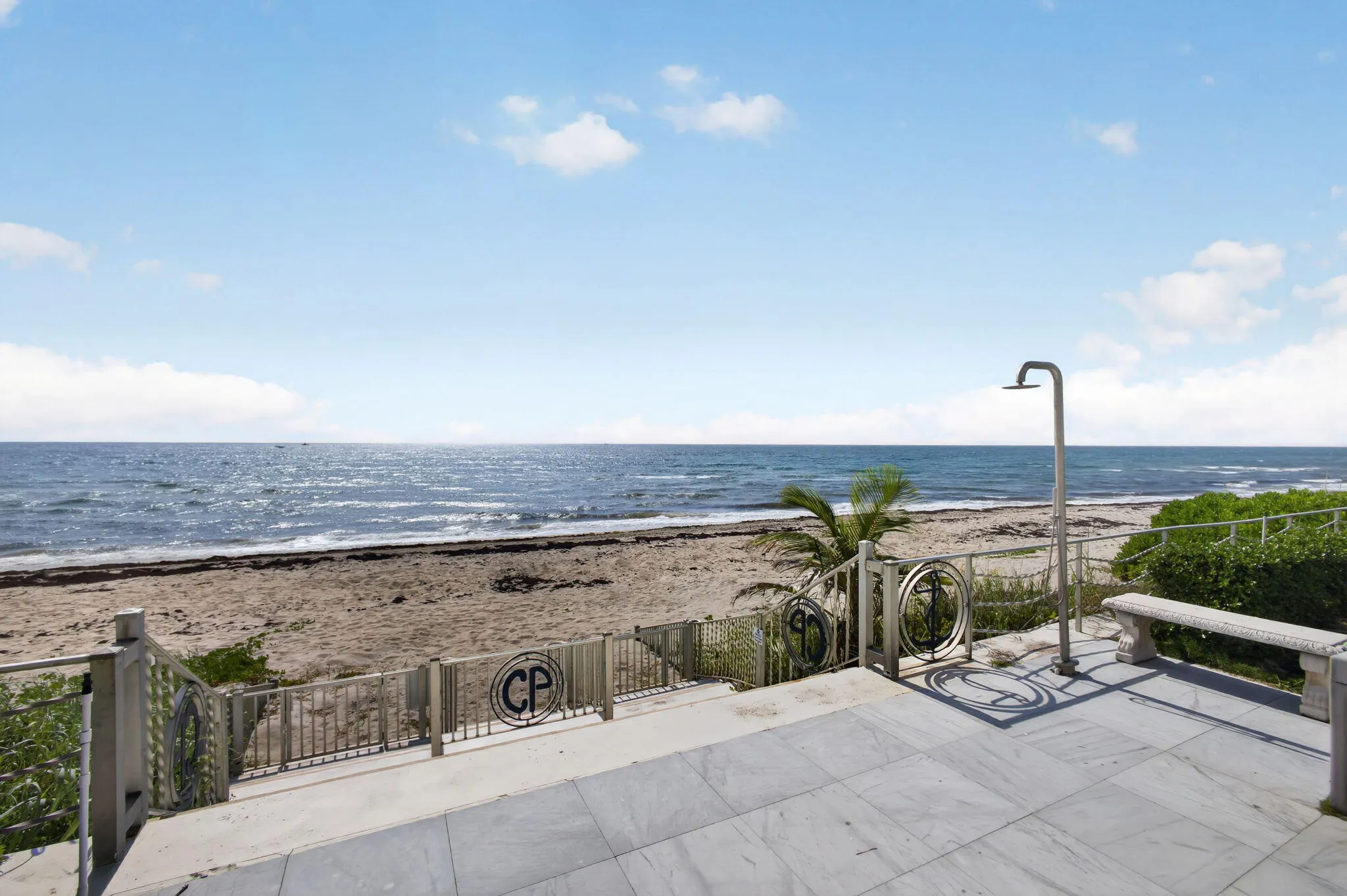 Oceanfront patio with large format tile flooring and direct beach access