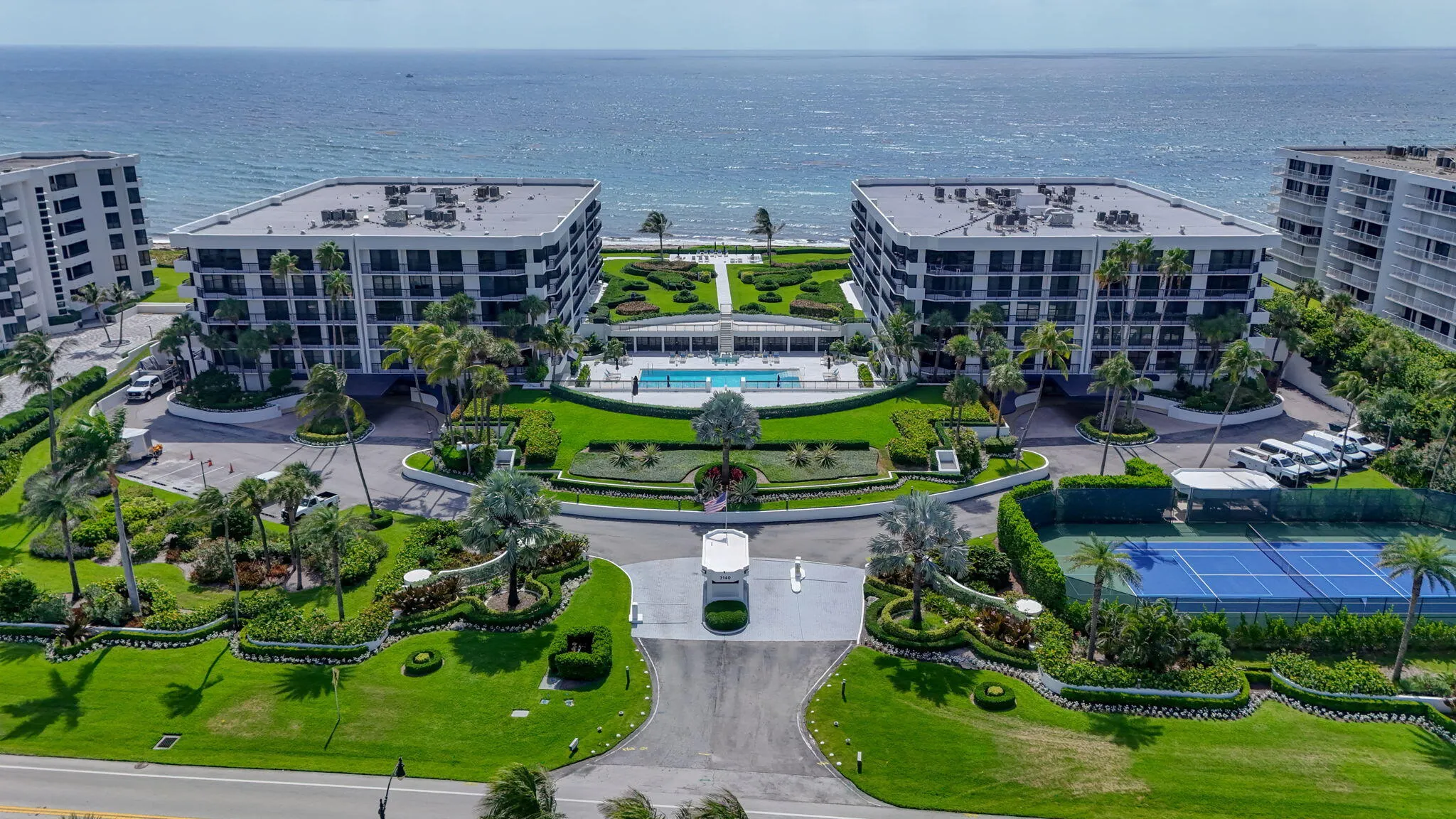 Oceanfront twin residential buildings featuring expansive landscaping