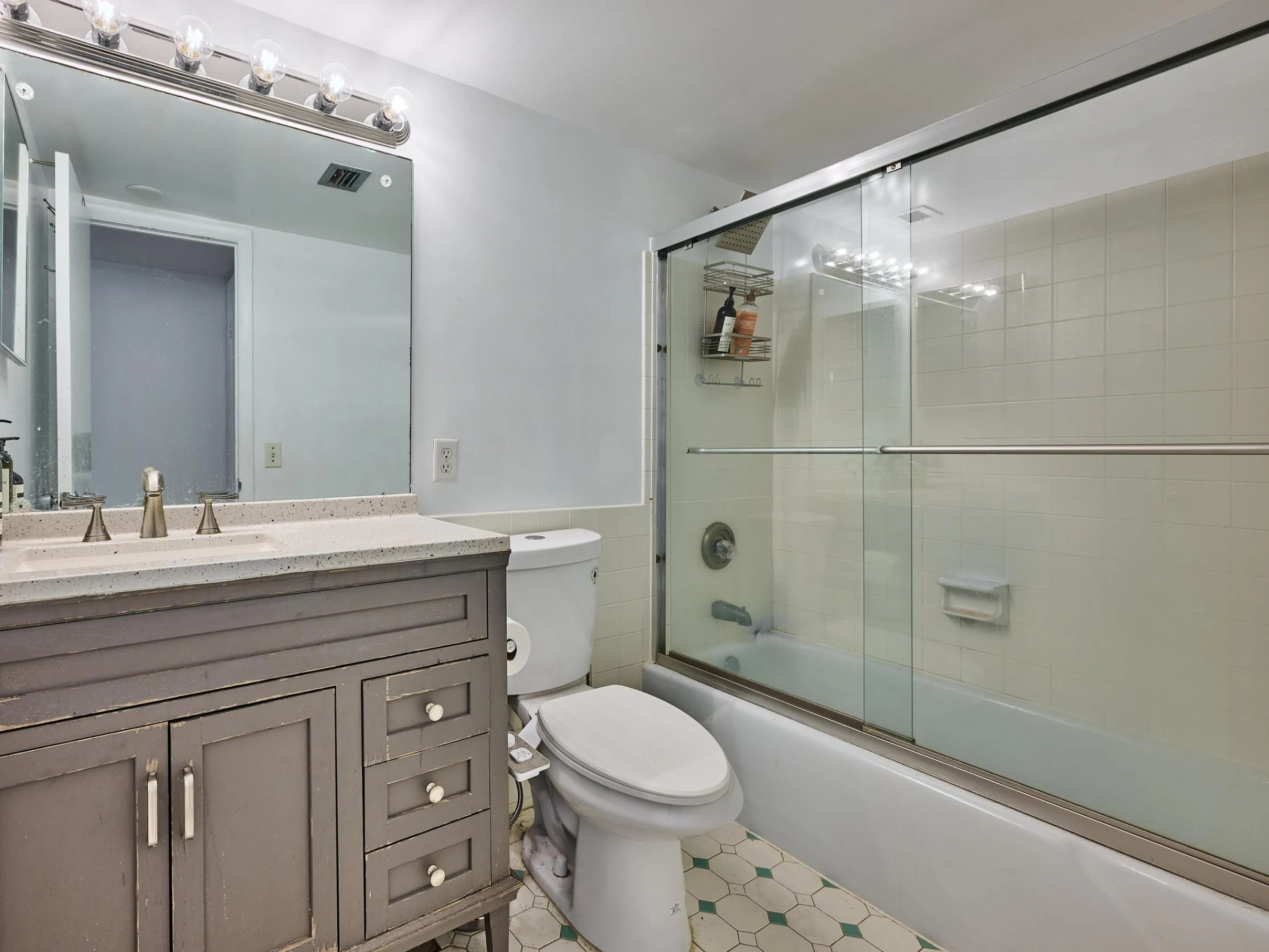 Guest Bathroom | Updated vanity with a tub/shower combination.