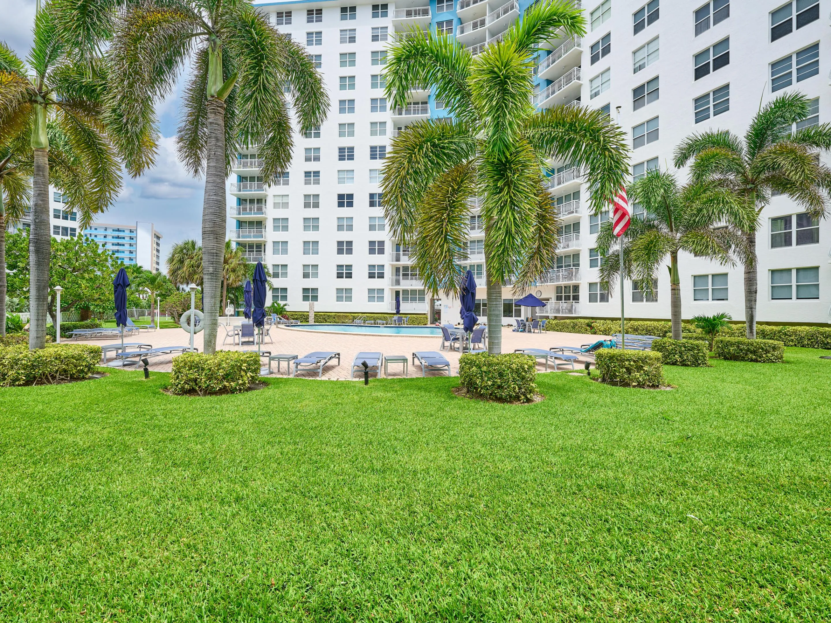 Landscaped Grounds | Beautifully maintained green space surrounding the pool.