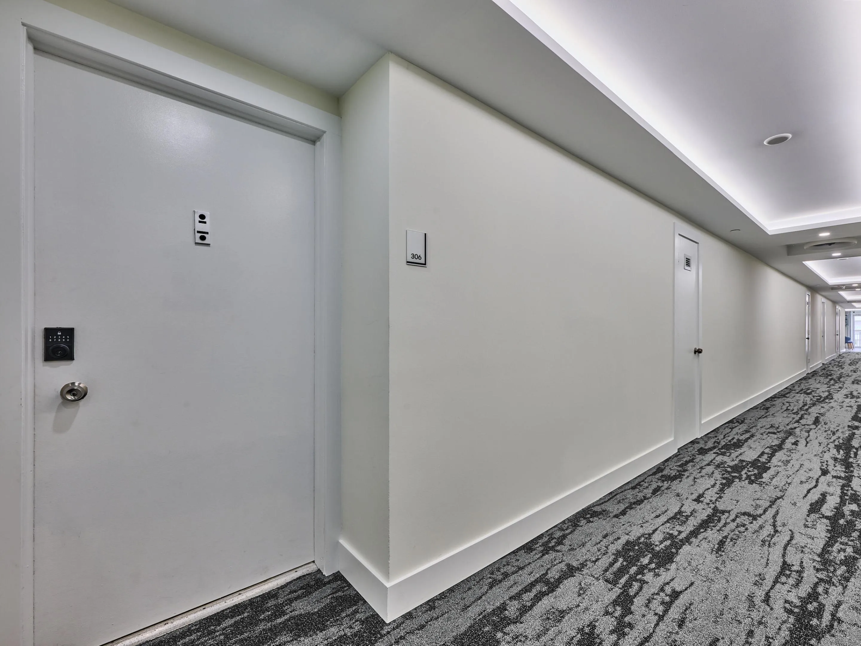 Hallway | Well-maintained common area with secure unit access.