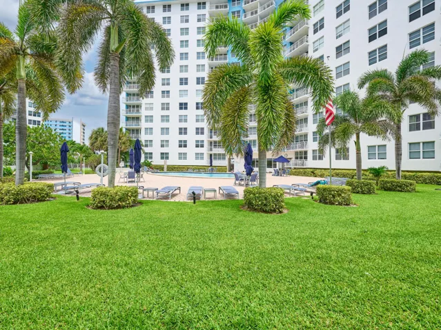 Landscaped Grounds | Beautifully maintained green space surrounding the pool.