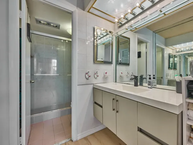 Primary Bathroom | Spacious vanity and glass-enclosed shower