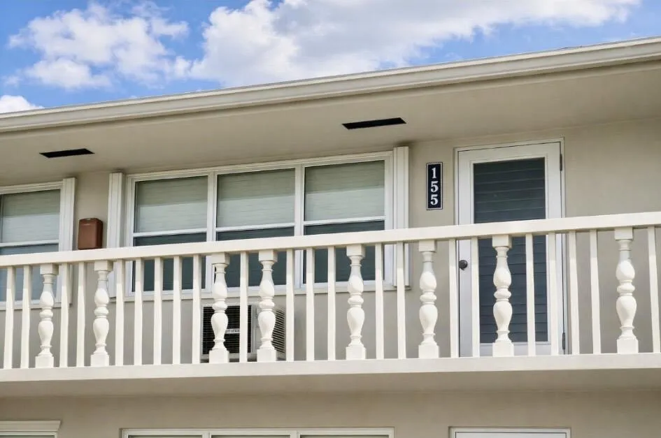 Upper-level unit featuring a privacy-screened entry door.