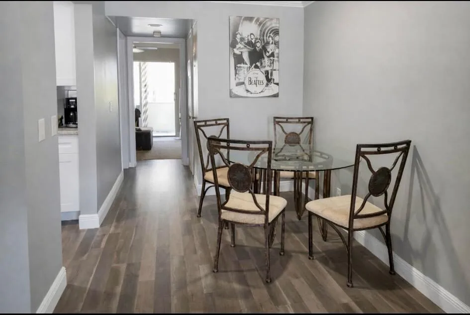 Wood look vinyl flooring extending from the entry into the kitchen area