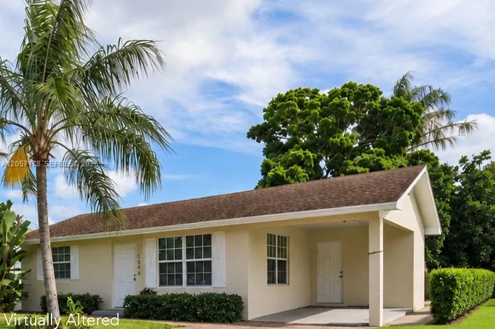 Single-story stucco exterior featuring a built-in carport, white window shutters, and a shingle roof