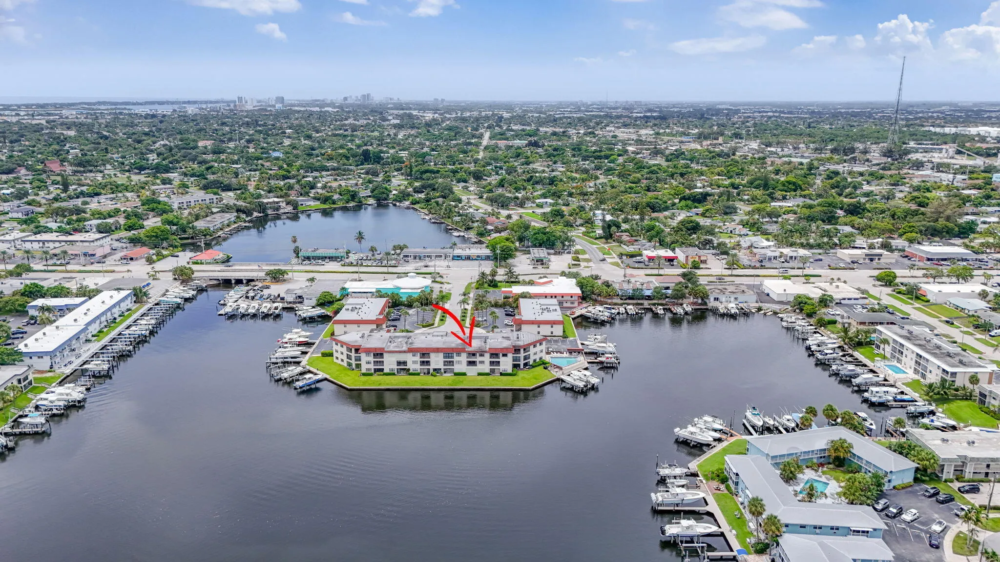 Waterfront condominium building featuring multiple levels and balconies